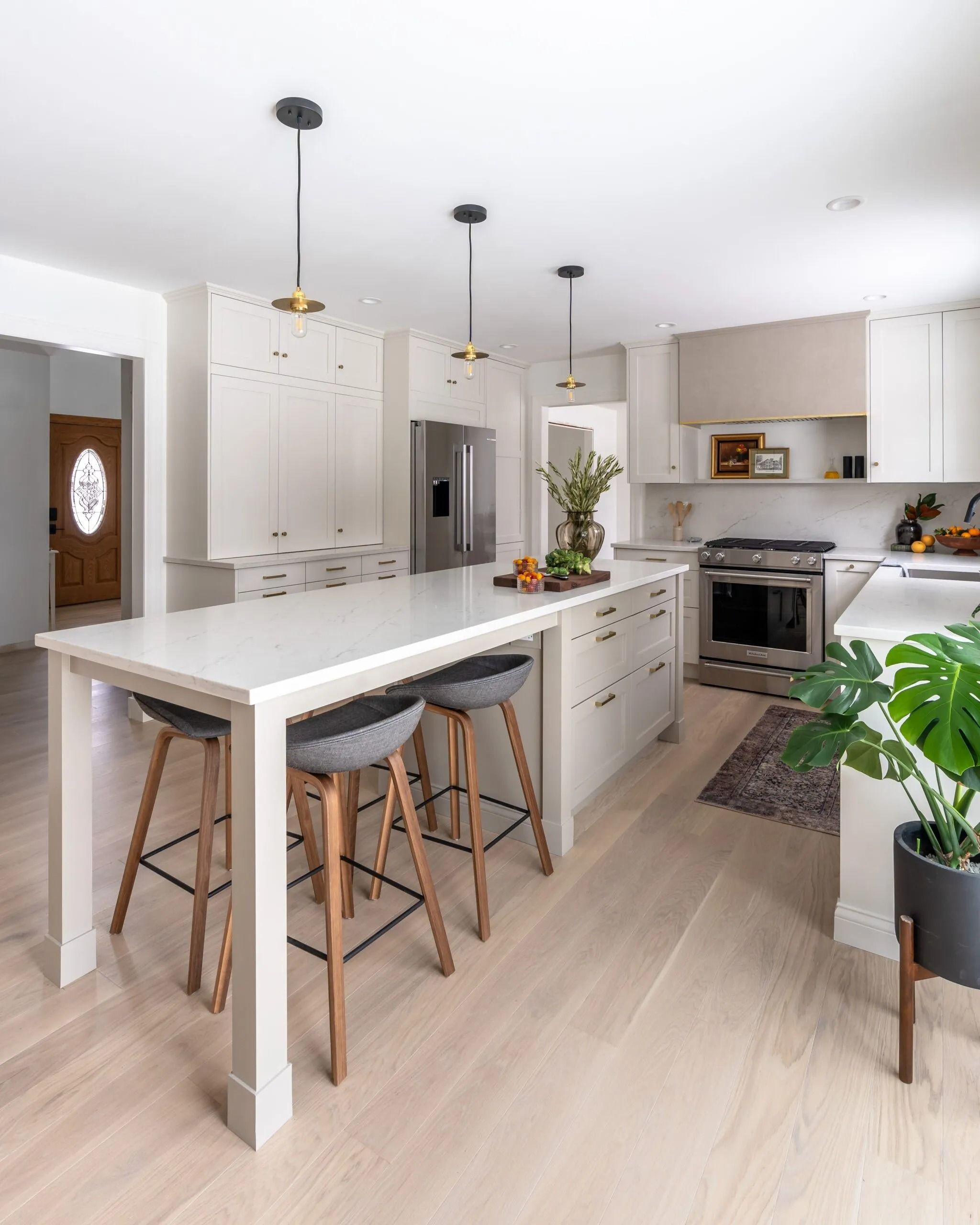Remodeled kitchen with large island and cream cabinetry